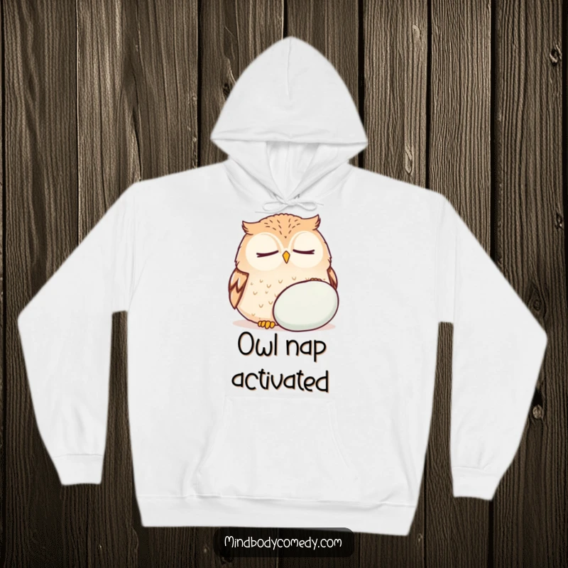 Funny owl breathing deeply near a cushion, featured on a warm hoodie for peaceful relaxation and humor.
