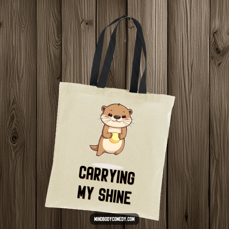 Funny tote bag showcasing a leaping otter with a glowing orb perfectly balanced on its nose, ready for adventure.